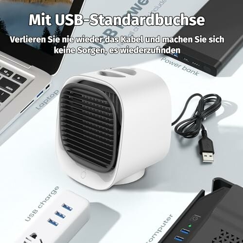 Kleines USB-Gerät auf Tisch mit Kabel und Elektronik.