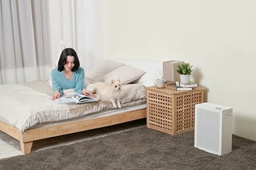 Frau liest auf dem Bett mit Hund daneben